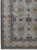 Corner detail of ivory Kashan rug with diamond cartouche border and sage green leaves