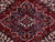 Close-up of the stepped navy and ivory central medallion surrounded by angular red field leaves