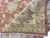 Folded corner revealing hand-knotted back, cotton foundation and white fringe of this oversize Peshawar rug