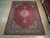 9'1" x 12'5" hand-knotted wool rug shown flat on a light wood showroom floor
