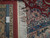 Ruler on the back proving authentic hand-knotted construction, tight weave and natural cotton fringe