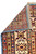 Back of the 8'7" x 10'8" Kazak rug folded to show tight hand-knotted weave