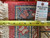 Back of the rug with tape measure and tag reading rug number 6002, size 10 x 16