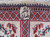 Woven signature cartouche in Persian script set into the ivory end border of the rug
