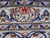 Detail of the woven signature cartouche in the border, Persian script on ivory with red device