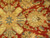 Detail showing large gold rosette with slate blue center, hand-knotted wool pile, Jaipur floral drawing