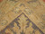 Corner detail of ivory guard border showing fine knotting and soft green and blue accents