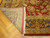 Folded corner reveals tight weave, ivory fringe and 3/8 inch wool pile on oak floor