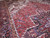 10x14 Heriz rug detail showing brick red field, ivory spandrel and olive guard border