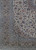 Corner detail showing olive green guard stripes, palmette border and rust floral accents on ivory