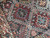 Close-up of hooked diamonds, eight-pointed stars and latch hook motifs in dense hand-knotted wool pile