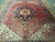 Large 10 x 13 Persian Heriz rug photographed lengthwise on stone flooring in natural light