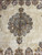Central medallion and pendant finials surrounded by open ivory ground in this square Persian rug