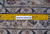 Ruler placed on the back showing fine hand-knotted wool weave and knots per square inch