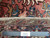 Back of the rug with ruler confirming authentic handmade cotton foundation and fine village knotting
