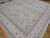 11'9" x 17'9" Pakistani Oushak rug on oak flooring with all over floral field and ivory borders