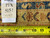 Back of the border with a dealer tag reading PIX 5151, 9' x 11'9", beside a tape measure