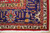 Corner detail showing navy border, ivory guard stripe, gold rosettes and hand-tied ivory fringe