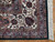 Corner detail showing ivory main border, slate blue guard stripes and clean cotton fringe