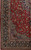 Corner detail showing indigo main border, ivory guard band and all over floral red field