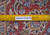 Reverse of the 9x13 Kashan rug with ruler showing fine even weave and cotton foundation