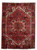 Full overhead view of 6'11" x 9'6" Persian Heriz rug with red field and navy border