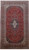 Red 9'6" x 16'5" Persian Kashan rug with navy medallion and ivory floral spandrels