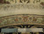 Reverse side with ruler showing knot density and Authentic Hand Knotted label on round rug