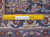 Back of the hand-knotted rug with ruler showing knot density and cotton foundation weave