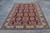 10' x 15'10" oversize Kazak rug laid flat on concrete showing the full paneled lattice