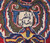 Woven signature cartouche in Persian script framed by olive, red and blue floral scrollwork