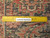 Back of rug with ruler confirming authentic handmade knot count and cotton foundation weave