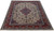 Angled floor view showing ivory field, rose medallion and brick red border of this 10x13 Persian rug