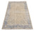 Full view of 7x11 khaki Oriental rug with denim blue floral border and ivory field