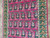 Overhead detail of paisley rows with pale blue centers, salmon collars and green shading