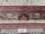 Ruler placed beside fringe measuring knots per square inch on authentic handmade 1970s Persian rug