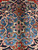 Macro detail of the ivory 8 petal rosette centered on a sky blue medallion ground