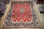 Full overhead view of 9'10" x 12'9" Persian Sarouk rug with red field and navy border