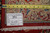 Back of the rug with tape measure and inventory tag confirming hand-knotted Persian construction