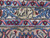 Woven signature cartouche in Persian script set into the ivory inner border of this rug