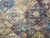 Purple, blue and taupe lattice panels each holding its own floral star medallion