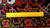 Back of the rug with ruler across tight hand-knotted rows in red, gold and green wool