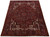 Angled full view of 9'10" x 12'11" hand-knotted Heriz wool rug in brick red