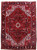 Deep apple red Persian Heriz rug with ivory geometric medallion and black border, full overhead view