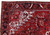 Corner detail of the black main border with ivory rosettes, serrated leaves and red guard stripes