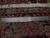 Ruler on rug back showing hand-knotted wool weave, cotton fringe and Authentic Handmade label
