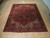 8'8" x 11' Heriz rug laid flat on light wood floor showing full geometric layout