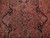 Close-up of stepped central medallion with sage green, sky blue and burgundy angular leaf motifs
