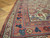 Corner detail of long Mahal runner with rosette and bird border on parquet wood flooring