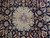 Close-up of ivory star medallion with blue rosette, palmettes and curling floral vine work